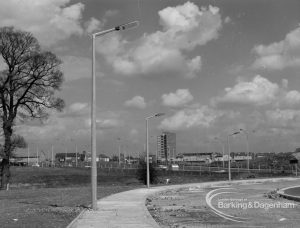 Street lighting, showing three columns overhanging Church Lane, Dagenham [Ballards Road end] and stones lying in road, 1968