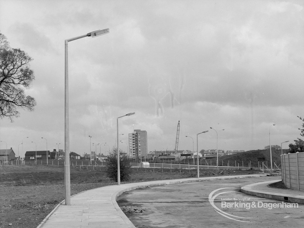 Street lighting, showing three columns overhanging Church Lane, Dagenham [Ballards Road end] and small heaps of debris still in gutter, 1968