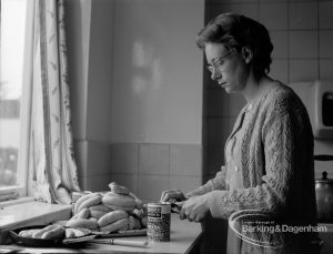 Child Welfare, showing warden Mrs Chapman preparing tea [possibly in house at 100 Balgores Lane, Gidea Park], 1968