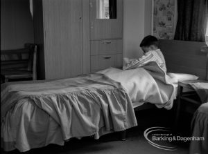 Child Welfare at Woodstock Hall House, Harold Wood, showing boy reading in bed, 1968