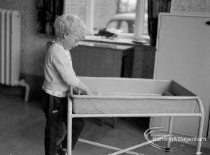 Child Welfare at Woodstock Hall House, Harold Wood, showing boy playing with play trough, 1968