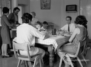 Child Welfare at Woodstock Hall House, Harold Wood, showing warden with others at lunch, 1968