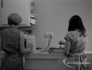 Child Welfare at Tudor House, 212 Becontree Avenue, Dagenham, showing two girls in kitchen with pie, 1968