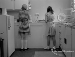 Child Welfare at Tudor House, 212 Becontree Avenue, Dagenham, showing kitchen and two girls, 1968