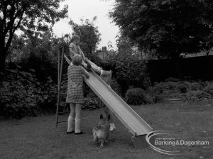 Child Welfare at Tudor House, 212 Becontree Avenue, Dagenham, showing three children and dog at slide in garden, 1968