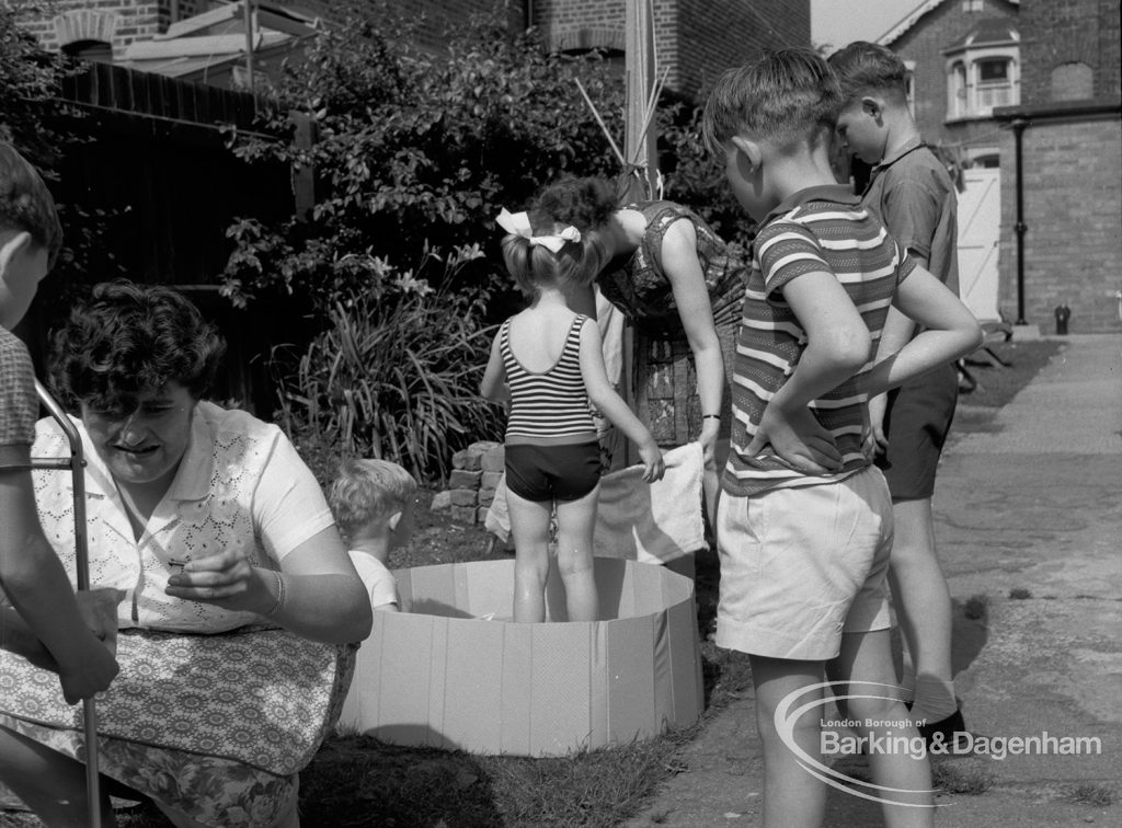 Child welfare at house at 26 – 28 Manor Road, Romford, showing girl in tub with towel and two boys at right, 1968