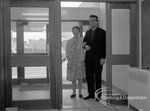 Welfare, showing Leys Avenue Occupational Centre for the Physically Handicapped, Dagenham, with patient and member of staff at entrance facing reception desk [building officially opened 15 October], 1968
