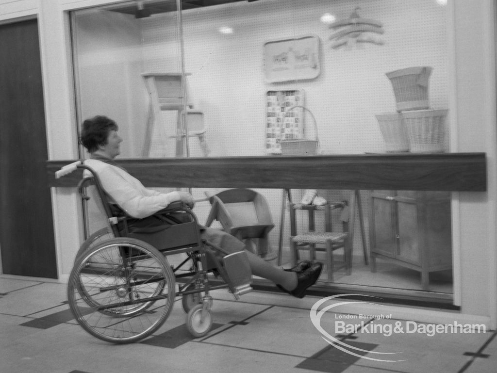 Welfare, showing Leys Avenue Occupational Centre for the Physically Handicapped, Dagenham, with wheelchair user looking at crafts on display, 1968