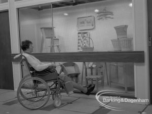 Welfare, showing Leys Avenue Occupational Centre for the Physically Handicapped, Dagenham, with wheelchair user looking at display of articles made at Centre, 1968