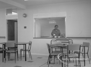 Welfare, showing Leys Avenue Occupational Centre for the Physically Handicapped, Dagenham, with the canteen with tables and chairs and a member of staff pouring tea, 1968