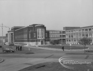 Civic Centre, Dagenham, with portico on main building, extension on right, and man in right centre, 1969