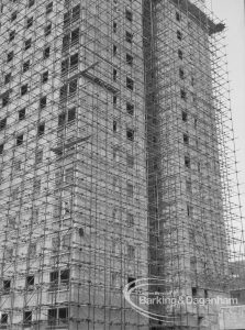 Becontree Heath housing development, showing lower half of unfinished tower block in scaffolding, 1969