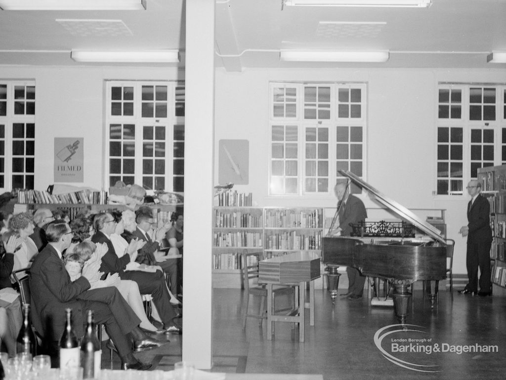 Rectory Library Music Circle twenty-first anniversary, showing members of audience and man standing next to piano, 1969