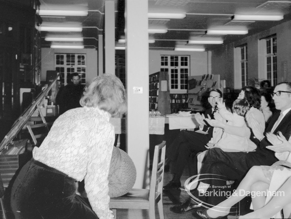 Rectory Library Music Circle twenty-first anniversary, showing woman bowing after her song performance and audience applauding, 1969