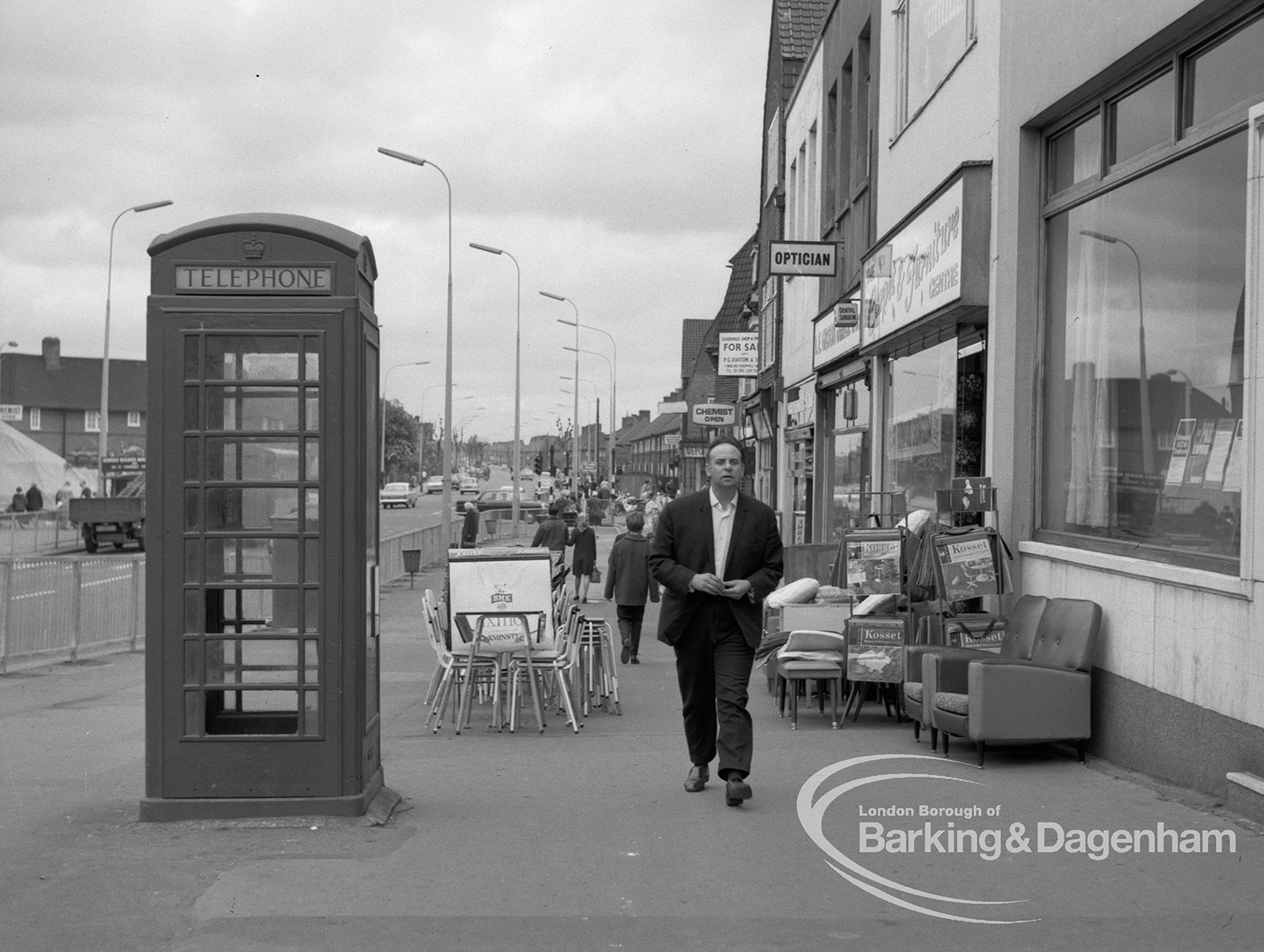 London Borough Of Barking Shops Act Inspector Showing Furniture Obstructing Pavement At 274 Heathway Dagenham Looking North With Owner Approaching 1969 Barking And Dagenham Archive Photos
