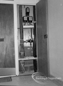 London Borough of Barking Borough Heating Engineer, showing meters at right angles in cupboard at Wellington Drive, Dagenham flats, 1969