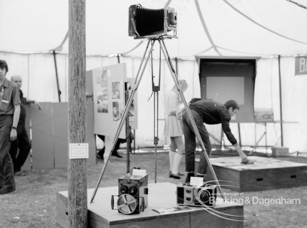 Dagenham Town Show 1969, showing Barking Photographic Society exhibition with plate camera on tripod, 1969