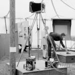Dagenham Town Show 1969, showing Barking Photographic Society exhibition with plate camera on tripod, 1969
