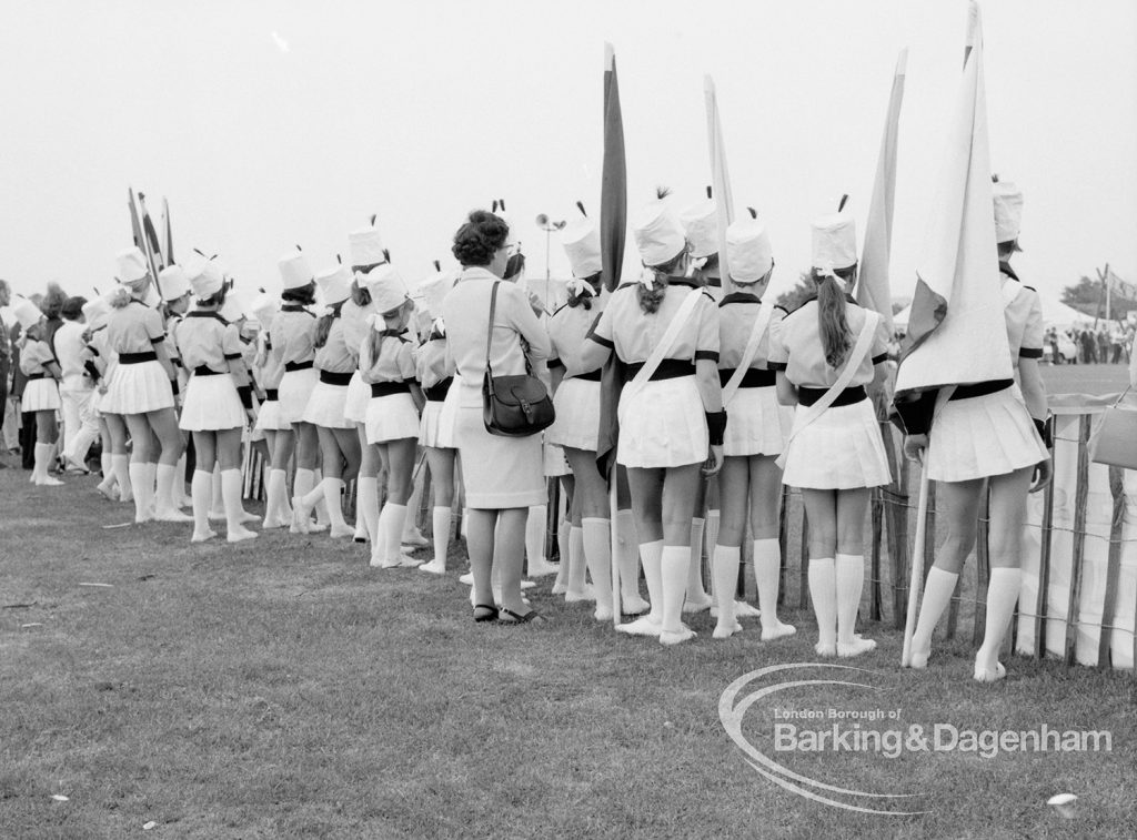 Dagenham Town Show 1969, showing majorettes watching as observers, with backs to camera, 1969