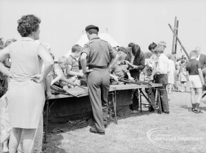 Dagenham Town Show 1969, showing soldiers supervising display of weapons on table, 1969