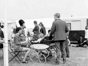 Dagenham Town Show 1969, showing visitors including young mother, seated with pram, and man standing, 1969