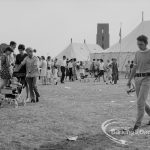Dagenham Town Show 1969, showing competitor (at right) and visitors, with marquees behind, 1969