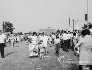 Dagenham Town Show 1969, showing a family and other visitors in a crowded main avenue, 1969