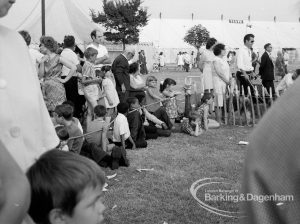 Dagenham Town Show 1969, showing a stretch of spectators, standing by paling and watching event, 1969
