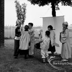 Rectory Library, Dagenham production of ‘The Price of Wisdom’ in grounds of library, produced by Mrs Jean Hickman, showing group of six players in oriental costume, with white banner, 1969