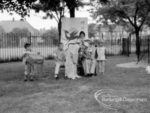 Rectory Library, Dagenham production of ‘The Price of Wisdom’ in grounds of library, produced by Mrs Jean Hickman, showing small group of players with dragon banner under trees, 1969