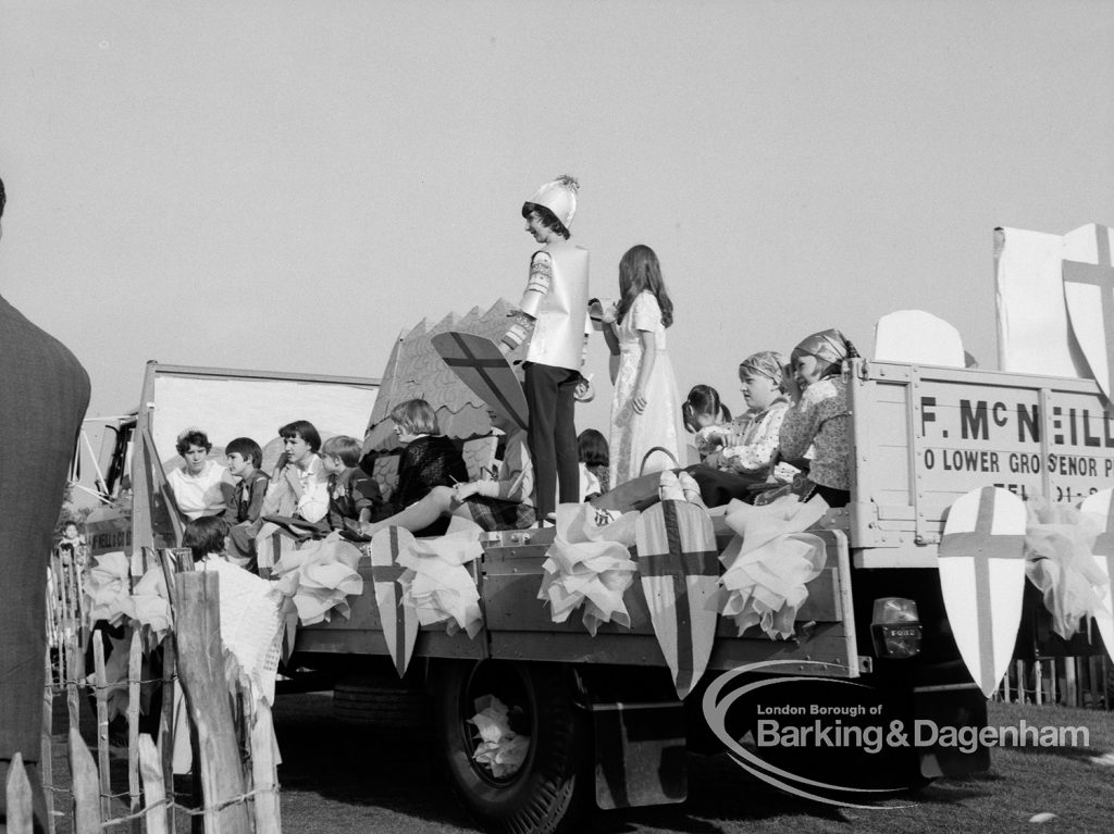 Crowd riding on carnival parade float at the Barking Carnival, 1969