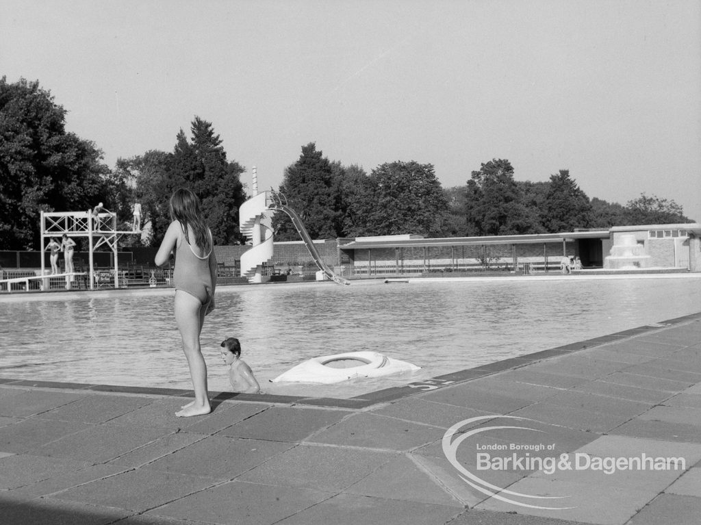 Two children playing in the water at the Barking Park open air Swimming Pool, 1969