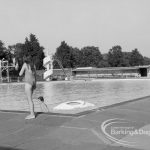 Two children playing in the water at the Barking Park open air Swimming Pool, 1969