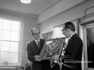Barking and Dagenham Chamber of Trade and Industry showing President Mr Andrews and Mayor Vic Rusha in Museum Room, Valence House, Dagenham holding insignia, 1970