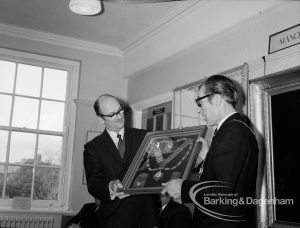 Barking and Dagenham Chamber of Trade and Industry showing President Mr Andrews and Mayor Vic Rusha displaying framed insignia in Museum Room, Valence House, Dagenham, 1970