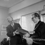 Barking and Dagenham Chamber of Trade and Industry showing a former Barking Chamber of Trade president handing over documents to Mayor Vic Rusha in Museum Room, Valence House, Dagenham, 1970