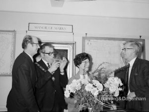 Barking and Dagenham Chamber of Trade and Industry showing President Mr Andrews, Mayor Vic Rusha, and Barking Libraries Department Chairman Alderman Mrs Thomas with bouquet in Museum Room, Valence House, Dagenham, 1970