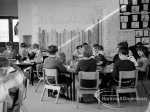New William Bellamy Primary School, Becontree Heath, showing classroom at west, with boys seated around tables and small whiteboard in upper right corner, 1970