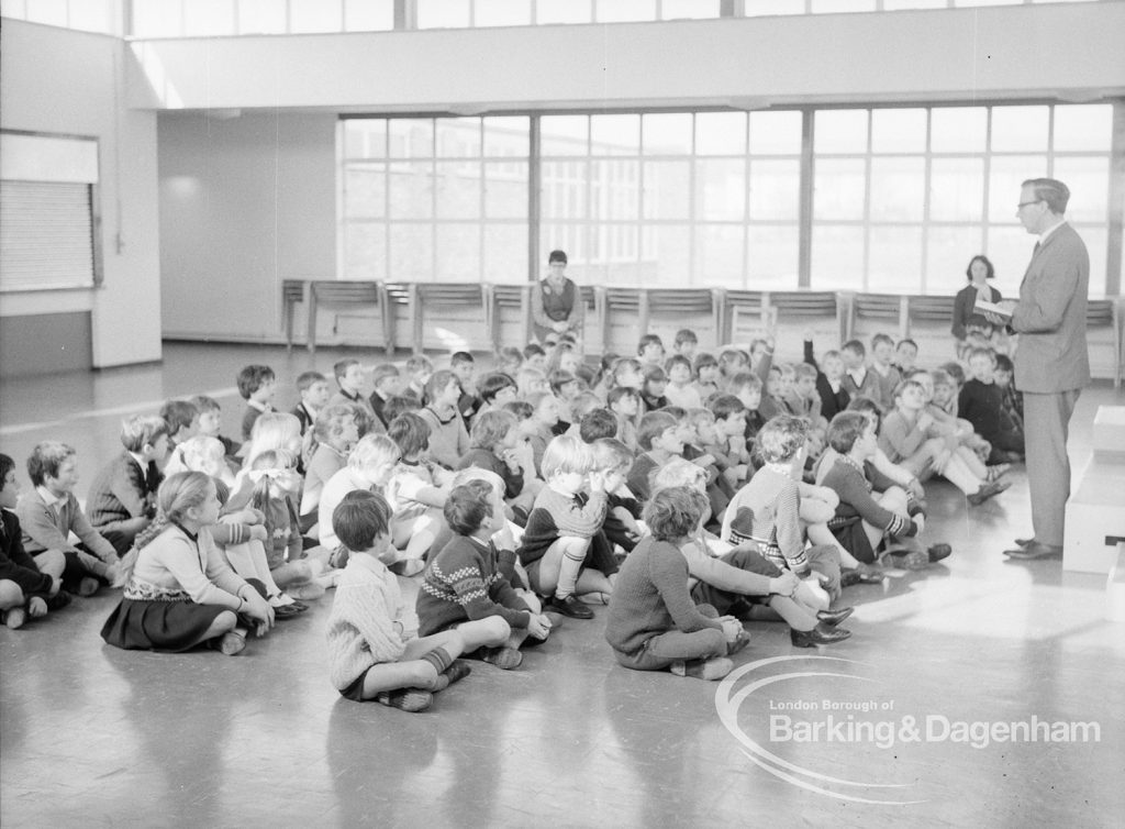 New William Bellamy Primary School, Becontree Heath, showing whole school of eighty children seated before headmaster in assembly hall, 1970