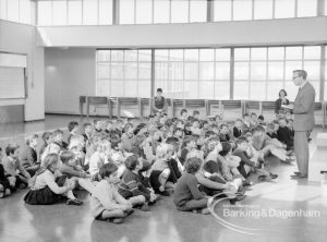 New William Bellamy Primary School, Becontree Heath, showing whole school of eighty children seated before headmaster in assembly hall, 1970