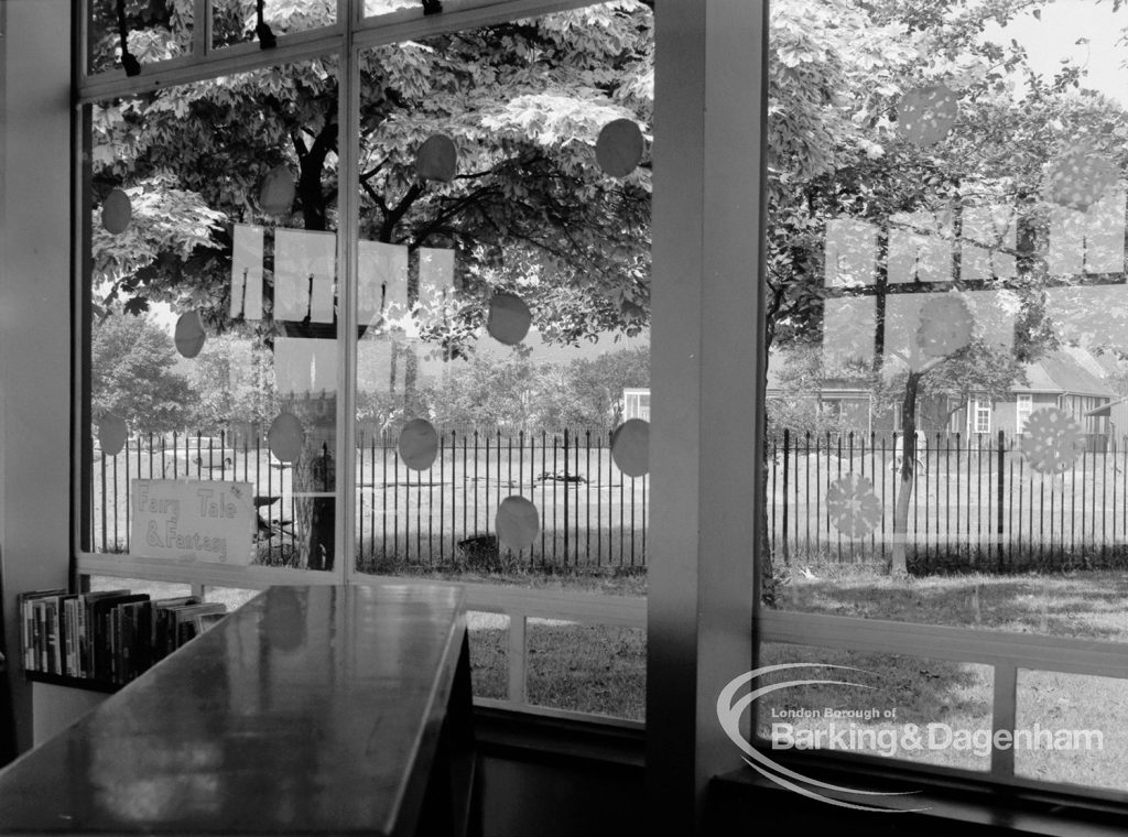 Rectory Library, Dagenham, showing view from children’s section through windows to garden at right, with warning discs on windows for birds, 1970