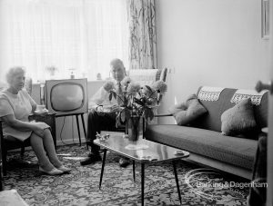 Housing at Grand Courts, Valence Wood Road, Dagenham, showing view of lounge in flat with settee to right and flowers on table, 1970