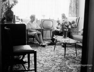 Housing at Grand Courts, Valence Wood Road, Dagenham, showing couple seated by window in lounge at flat, 1970