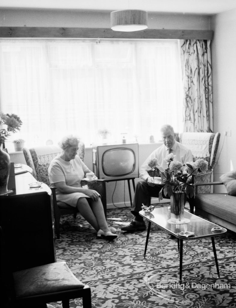 Housing at Grand Courts, Valence Wood Road, Dagenham, showing couple seated by window in lounge at flat, 1970