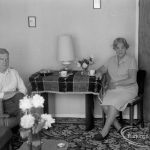 Housing at Grand Courts, Valence Wood Road, Dagenham, showing Mr and Mrs Bond seated at table at north end of lounge in flat number six, 1970