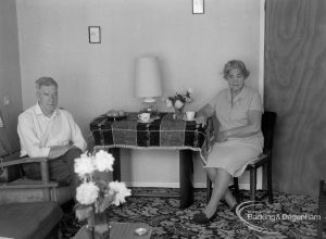 Housing at Grand Courts, Valence Wood Road, Dagenham, showing Mr and Mrs Bond seated at table at north end of lounge in flat number six, 1970