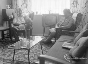 Housing at Grand Courts, Valence Wood Road, Dagenham, showing Mr and Mrs Bond seated either side of television in lounge at flat number six, 1970