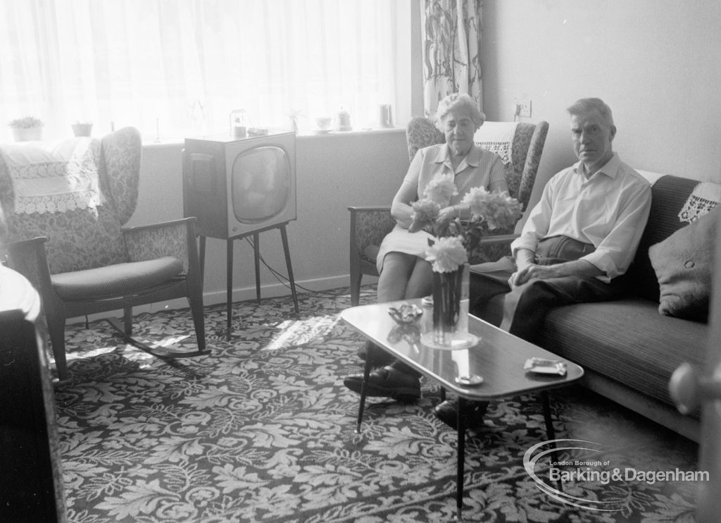 Housing at Grand Courts, Valence Wood Road, Dagenham, showing Mr and Mrs Bond seated together in corner at south end of lounge in flat number six, 1970