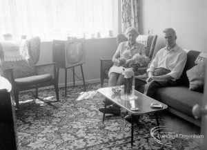 Housing at Grand Courts, Valence Wood Road, Dagenham, showing Mr and Mrs Bond seated together in corner at south end of lounge in flat number six, 1970