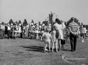 Dagenham Town Show 1970, showing a young family by arena approaching Majorettes, 1970